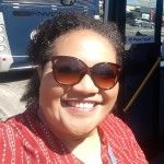 A head and shoulders photo of Karlena with a big smile and sunglasses